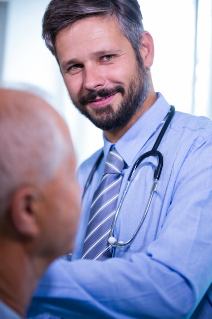 Male doctor giving an injection to a patient at the hospital