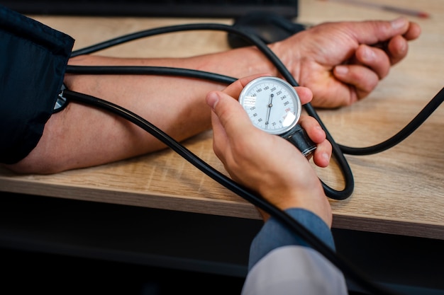 Male doctor hand measuring tension