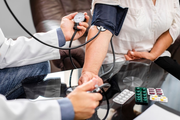 Male doctor hands measuring tension to a patient