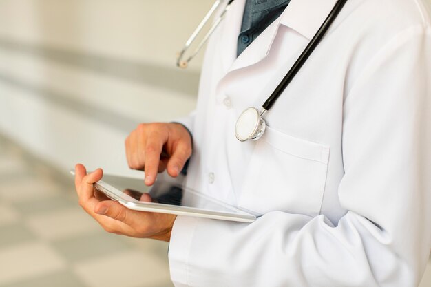 Male doctor hands using a tablet