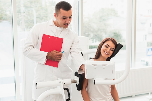 Male doctor helping female patient