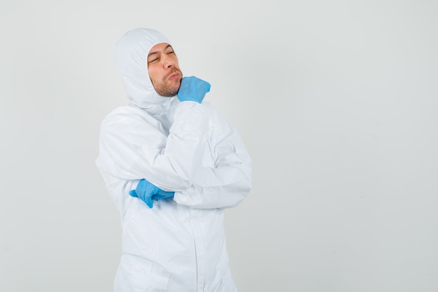 Male doctor looking away in protective suit