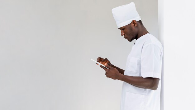 male doctor looking at his phone