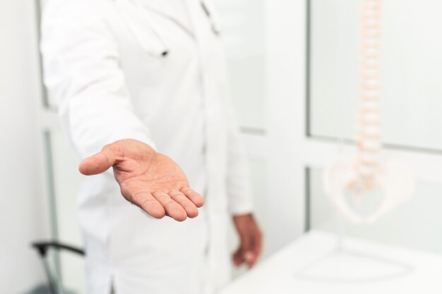 Male doctor offering his hand