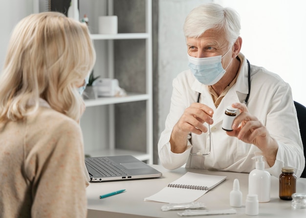 Male doctor prescribing pills to patient