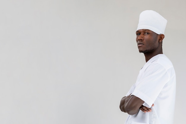 male doctor standing with arms crossed