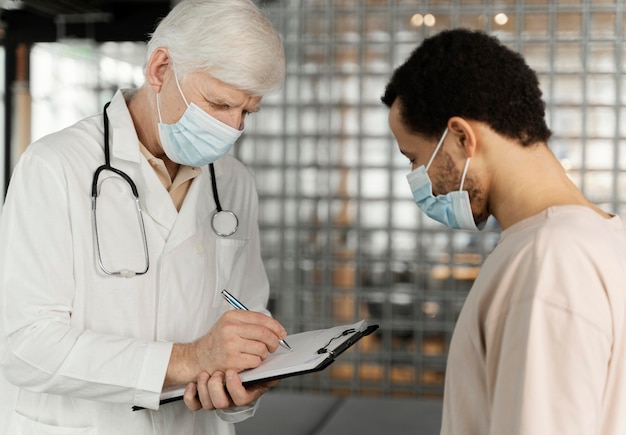 Male doctor talking with patient