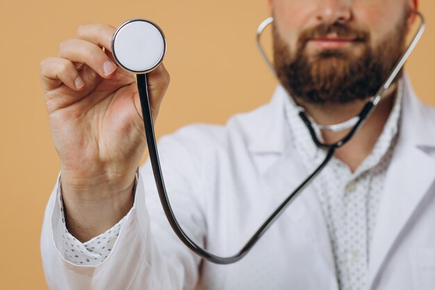 Male doctor with stethoscope standing isolated