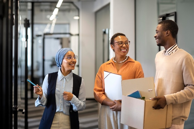 Male employee exploring his new new office job location while carrying box of belongings