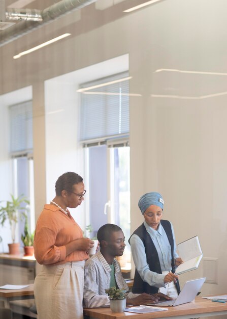 Male employee getting used to his new office job along with female colleagues