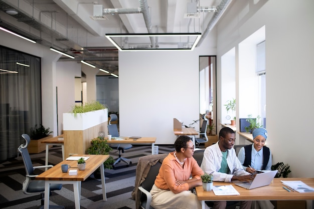 Male employee getting used to his new office job along with female colleagues