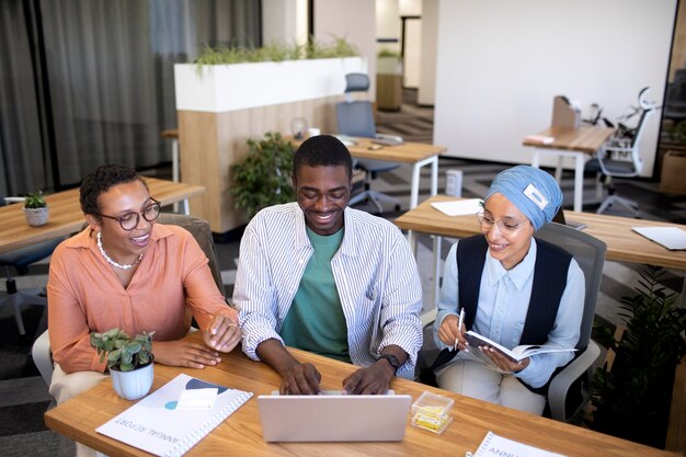 Male employee getting used to his new office job along with female colleagues