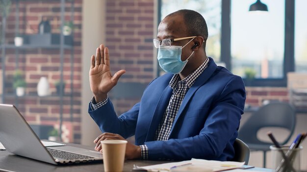 Male employee talking on remote videoconference call, attending business meeting with consultant on laptop. Using online video teleconference chat on internet, webcam remote conversation.