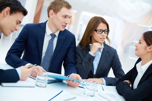 Male executive holding a blue folder at the meeting