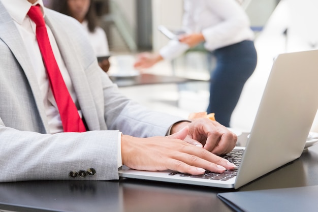 Male executive using laptop in cafe