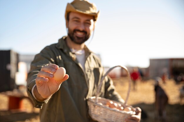 Male farmer holding egg from his farm