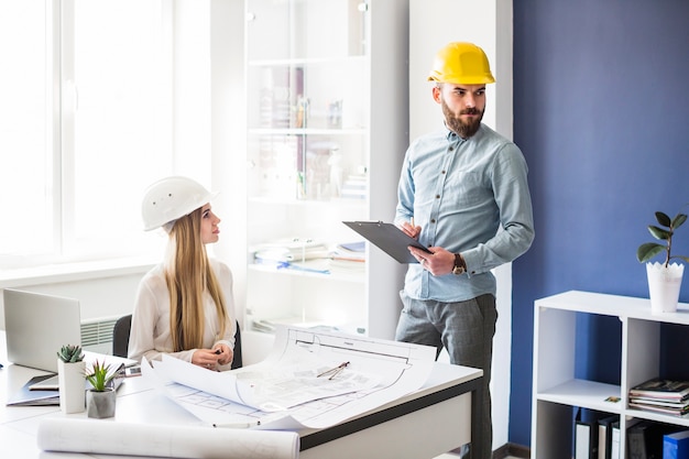 Male and female architect working in the office