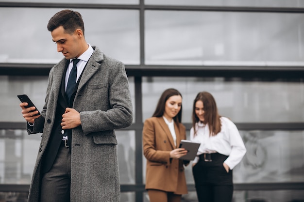 Male and female business people working on tablet in office