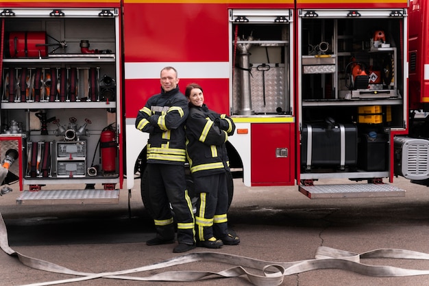 Male and female firefighters at the station working together