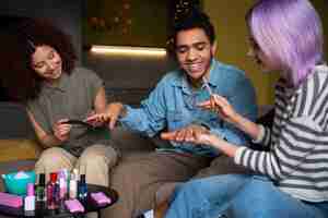 Free photo male and female friends getting a manicure together