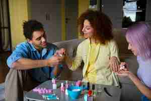 Free photo male and female friends getting a manicure together