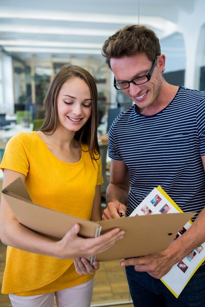 Male and female graphic designers interacting over a document