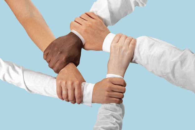 Male and female hands holding isolated on blue.