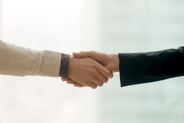 Free Photo male and female hands shaking, business handshake with copy space