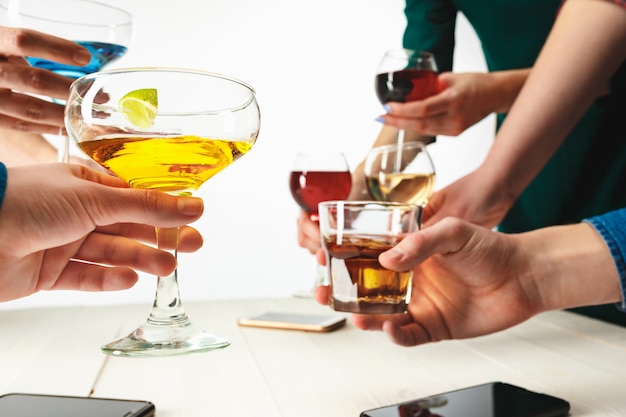 Male and female hands with exotic cocktails