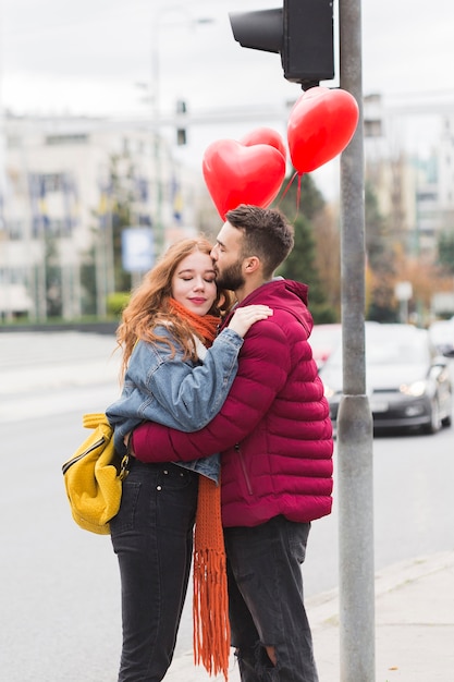 Male and female hugging medium shot