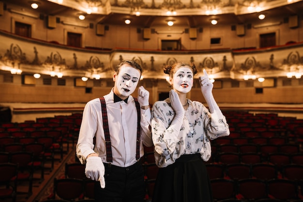 Male and female mime artist doing act like making phone calls