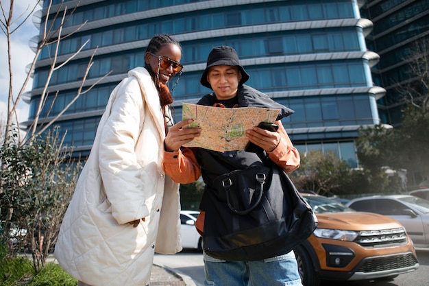 Free photo male and female tourists checking map