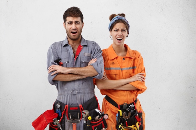 Male and female workers wearing work clothes