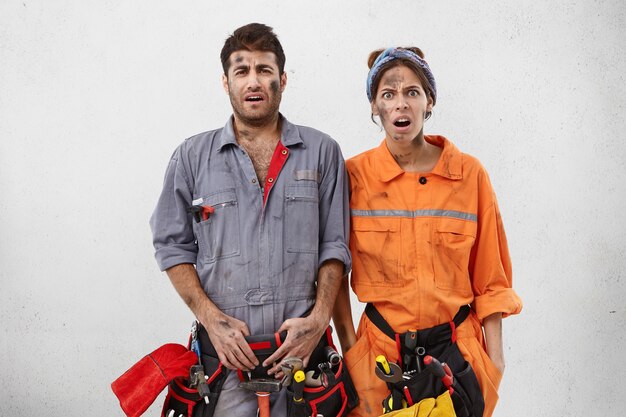 Male and female workers wearing work clothes