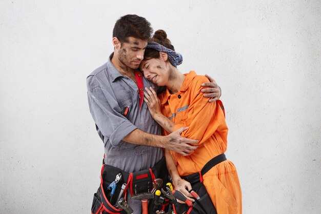 Male and female workers wearing work clothes