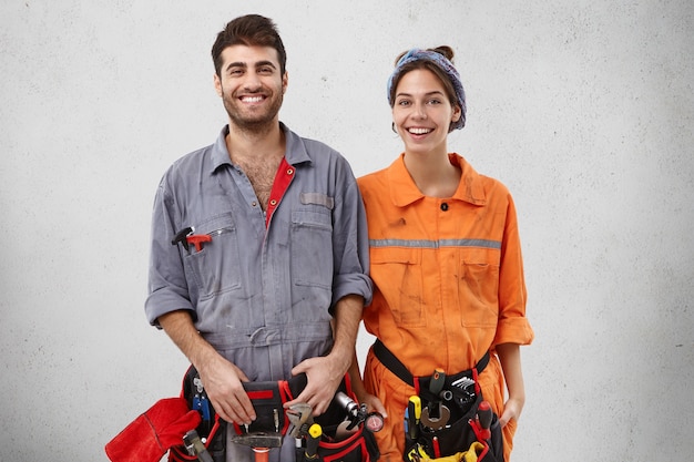 Male and female workers wearing work clothes