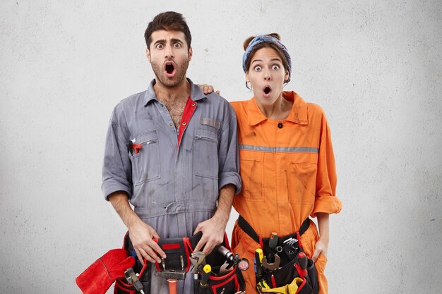 Male and female workers wearing work clothes