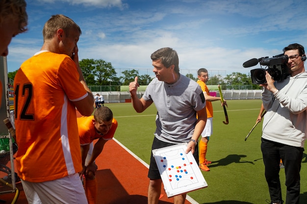 Free photo male field hockey coach on the arena