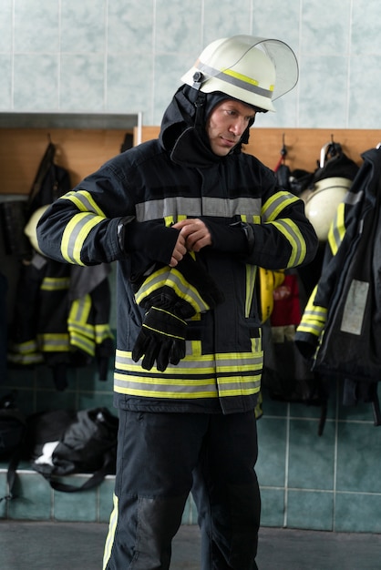 Male firefighter getting equipped at station
