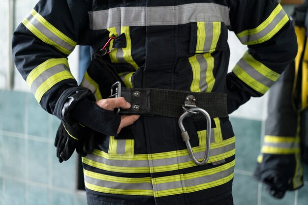 Male firefighter getting equipped at station