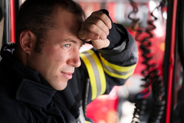 Male firefighter at the station inside fire truck