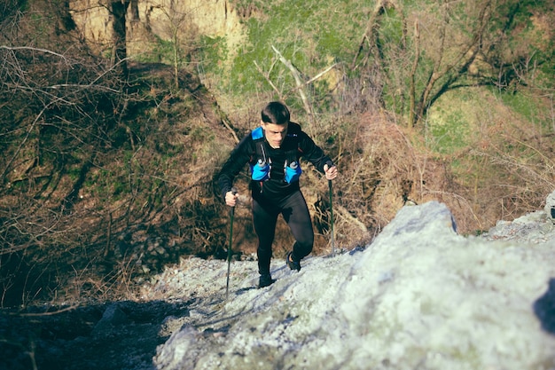 Male fit athlete walking outdoors at nature