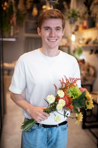 Male florist holding a beautiful bouquet