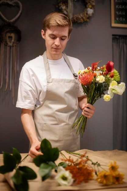 Male florist making a beautiful bouquet