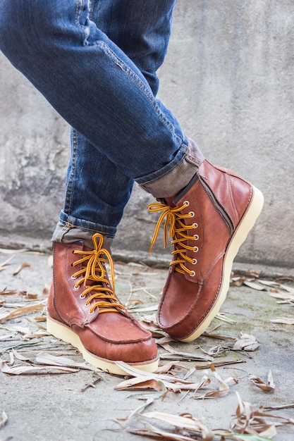 Male foot with brown leather shoes and jeans