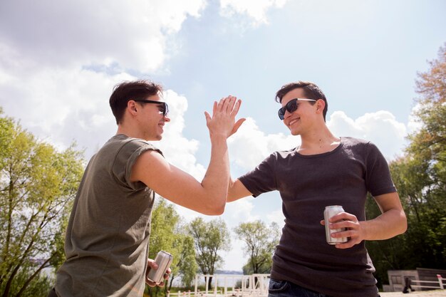 Male friends giving high five