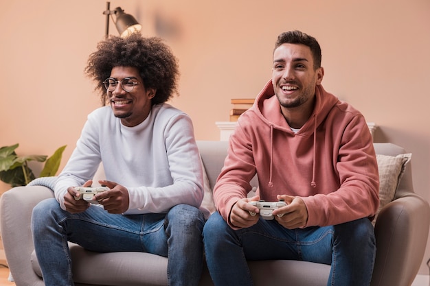 Free photo male friends at home playing games