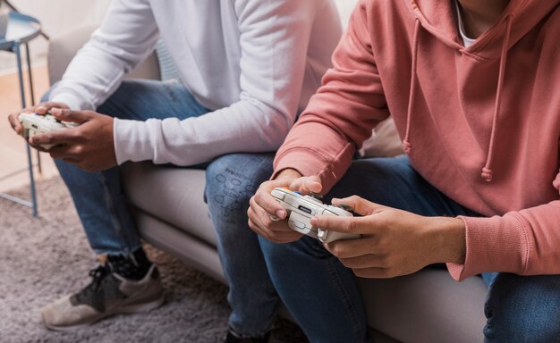 Male friends at home playing games