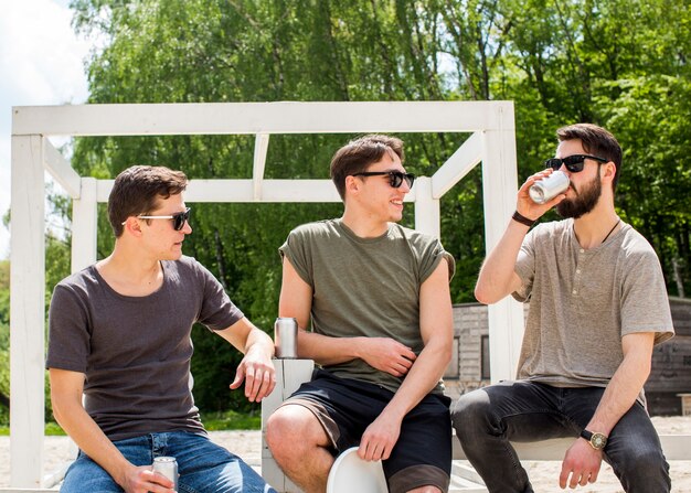 Male friends relaxing with refreshing drinks