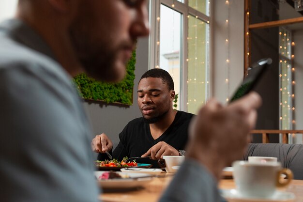 Male friends at restaurant eating